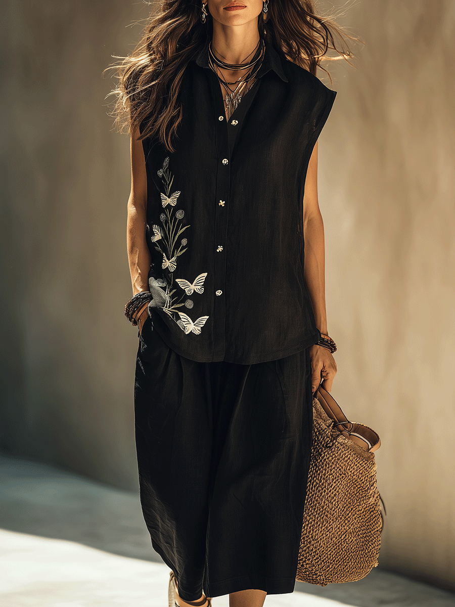 Front view of black floral-embroidered loose-fit shirt and mid-length shorts set