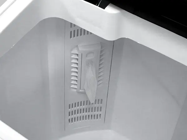 Closeup of the removable lint filter inside the Kenmore twin tub laundry machine
