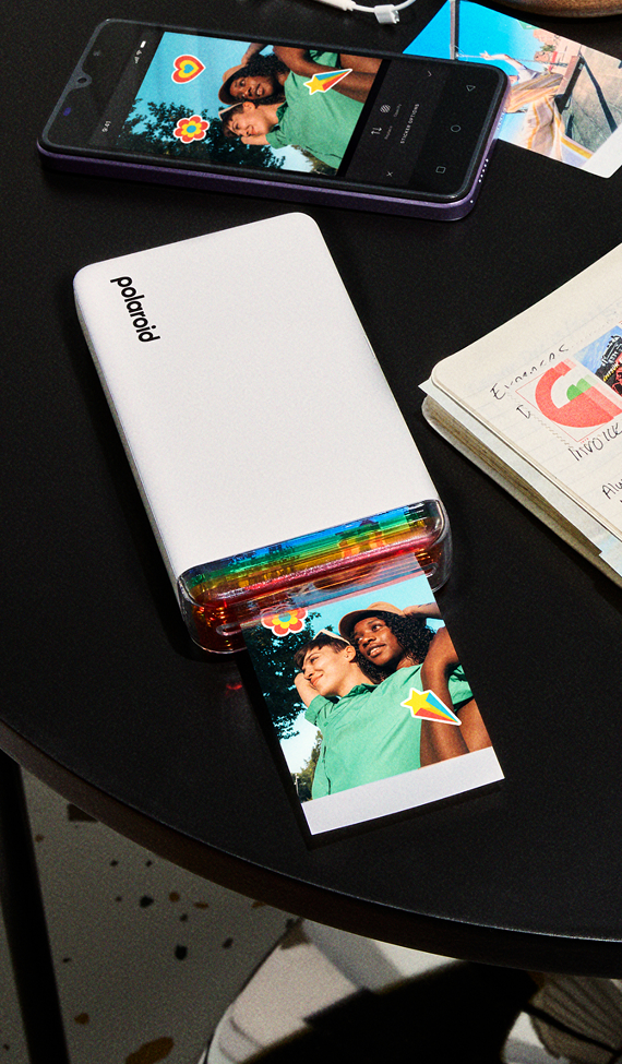 White Polaroid Hi-Print printer printing a colorful photo