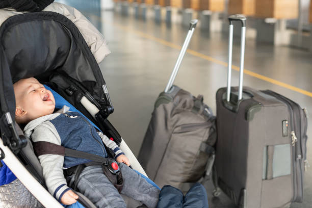 Child in stroller with separate luggage at the airport
