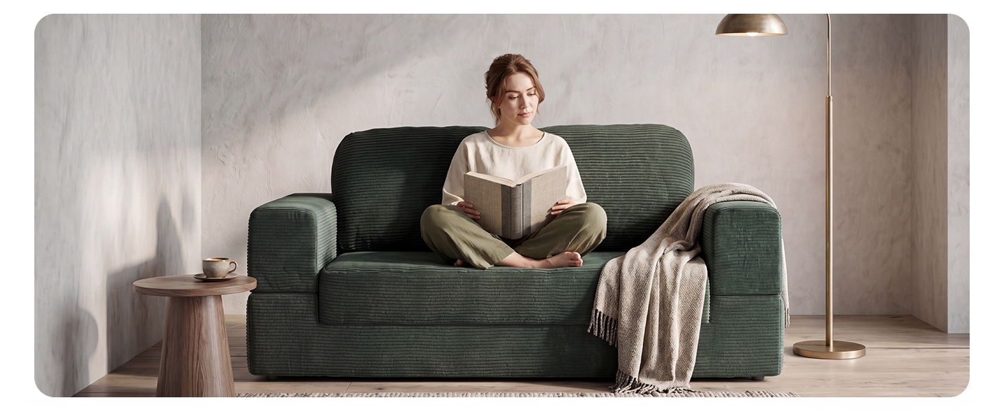 Corduroy frameless loveseat couch providing comfortable seating for reading in a small apartment.