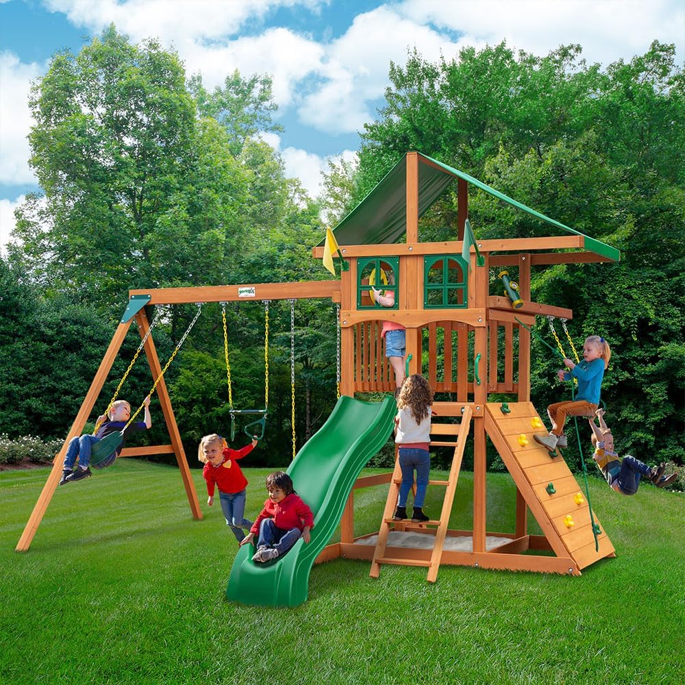 Gorilla Playsets 01-1080 Avalon Treehouse Wooden Swing Set with Oversized Green Vinyl Canopy Roof, Trapeze Arm, Climbing Wall, Ladder, Swings and Slide