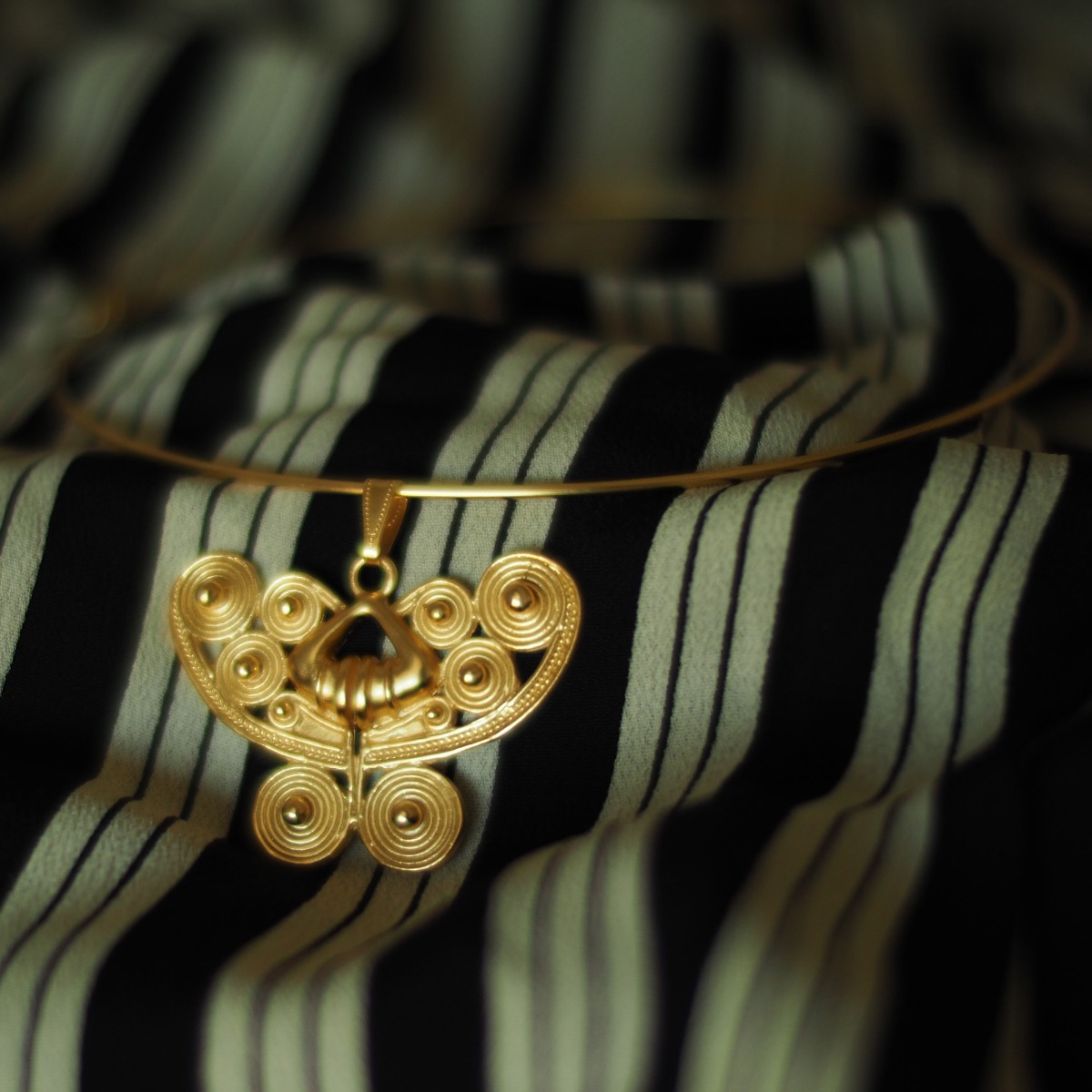 Across The Puddle, Historical Jewelry Collection, 24k Gold Plated Omega Choker Necklace with a Pre-Columbian Spirals Butterfly Pendant