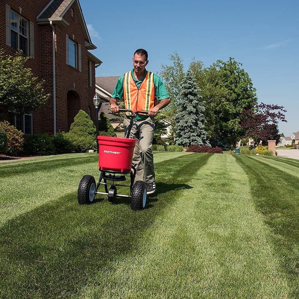 Earthway Even Spread 2150 Commercial 50 LB Broadcast Fertilizer Spreader. Red, Heavy-Duty Walk-Behind Push Garden Seeder with Adjustable Drop Rate and Driving Handle. Large 13 inch Pneumatic Stud Tires