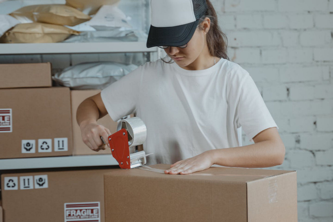 Person taping boxes
