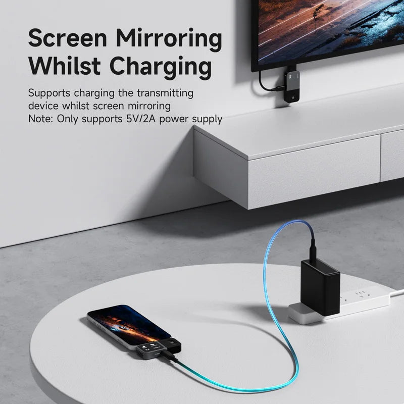 Phone screen mirroring to a TV with charging cable on a modern setup
