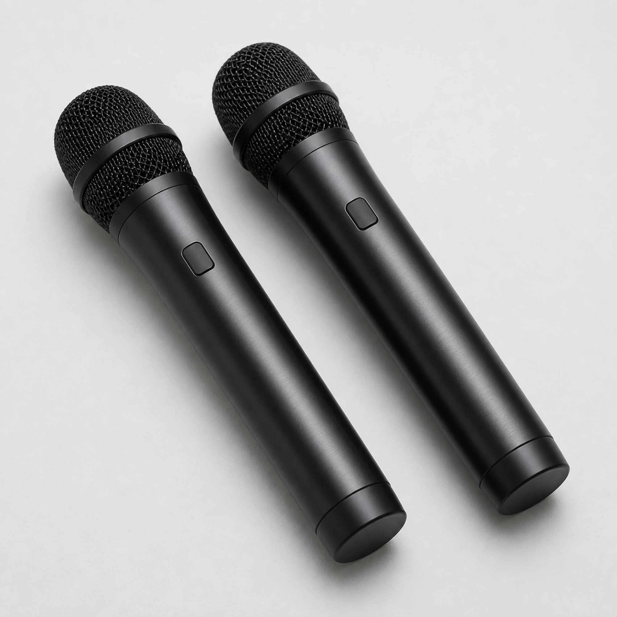 Pair of included black wireless microphones with woven metal grilles