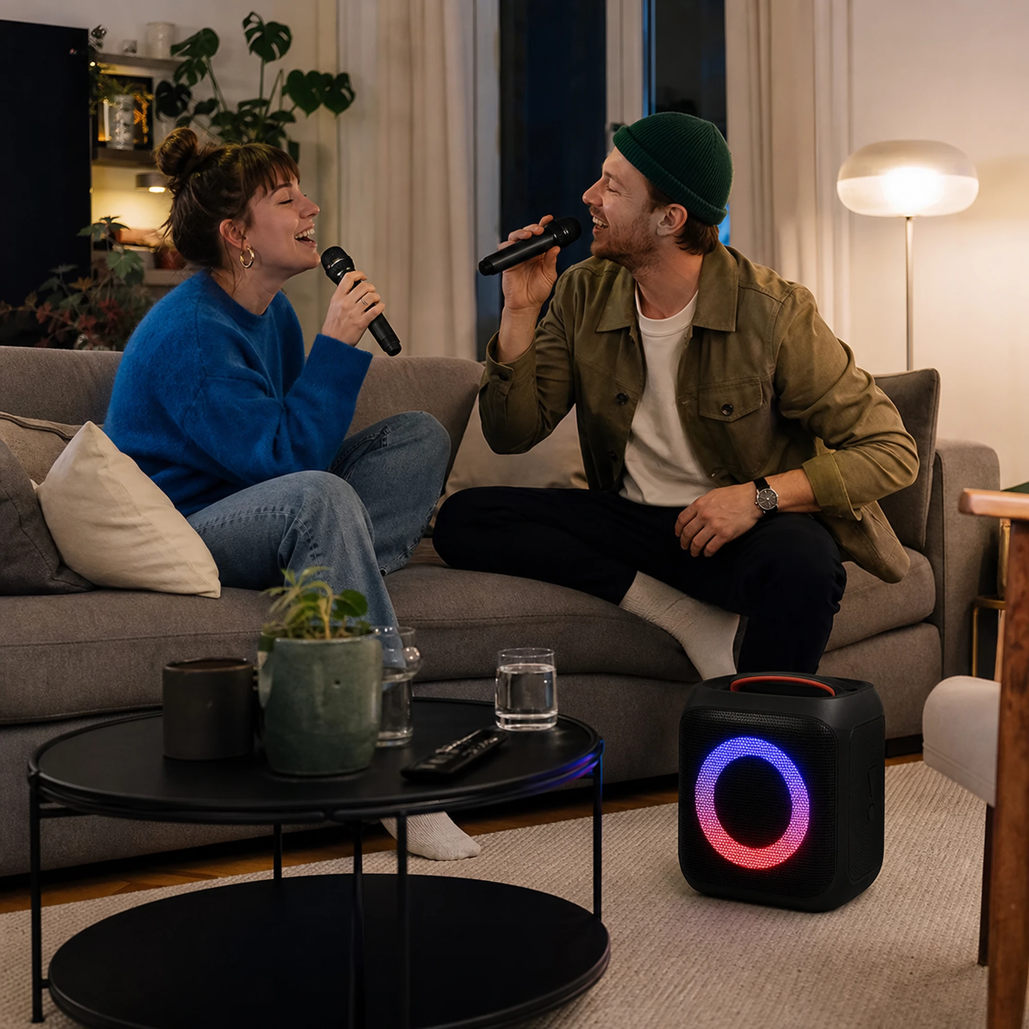 Two people using the wireless microphones with the speaker at home