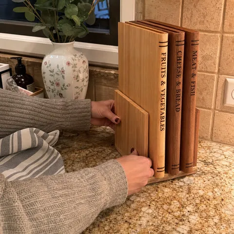 Three book-style boards stored upright after kitchen cleanup