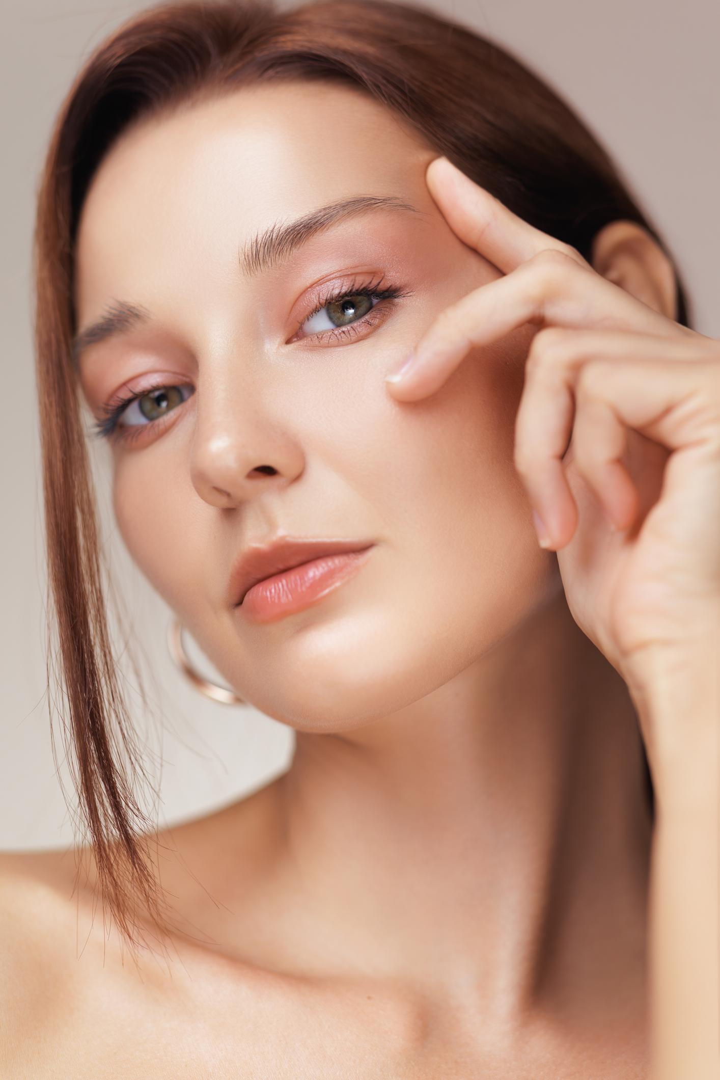 Macro Portrait Of Woman Applying Skincare Under Eye In Anti-Aging Ad