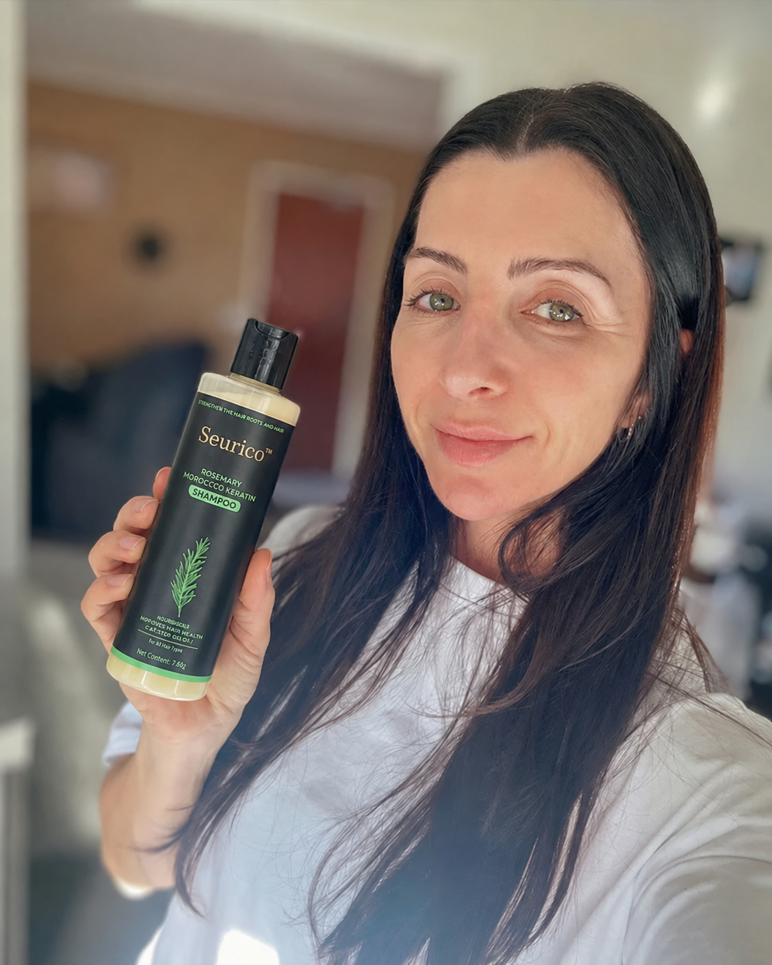 Seurico customer holding shampoo bottle