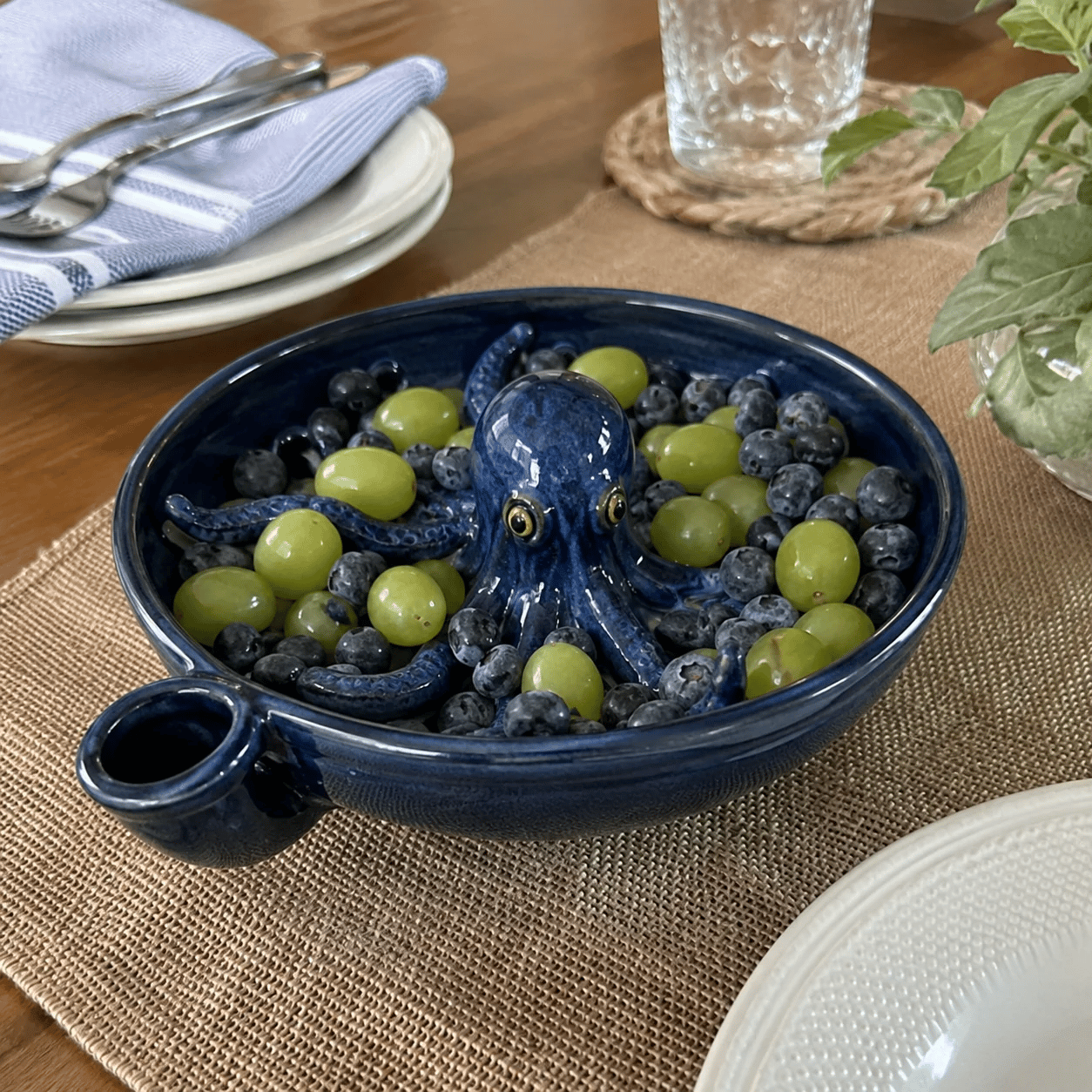 Octopus colander serving grapes on dining table