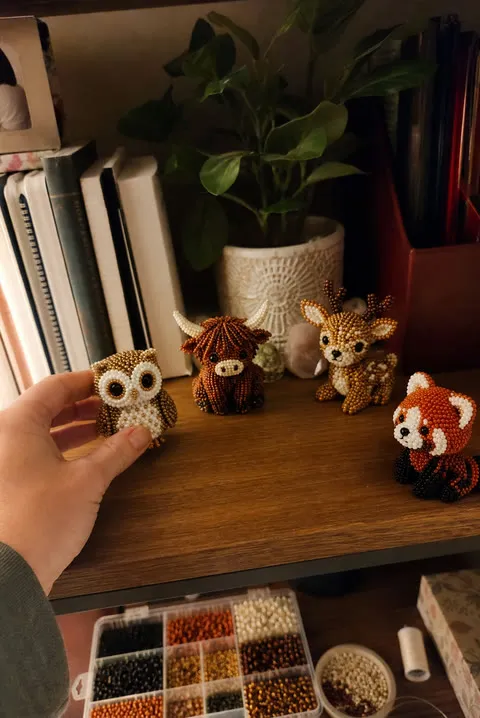 Finished beaded animal figures displayed on a shelf