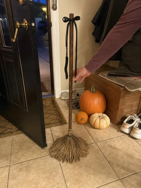 A hand activates the broom in an entryway