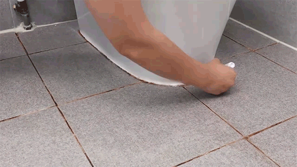 Applying grout repair pen to stained tile lines