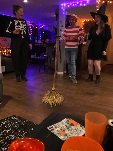 Halloween party guests react to the moving broom