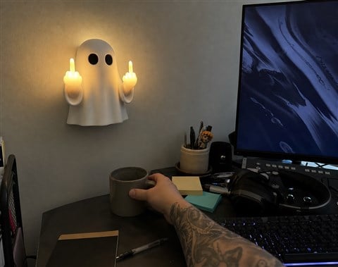 Ghost wall light mounted above a casual home office desk