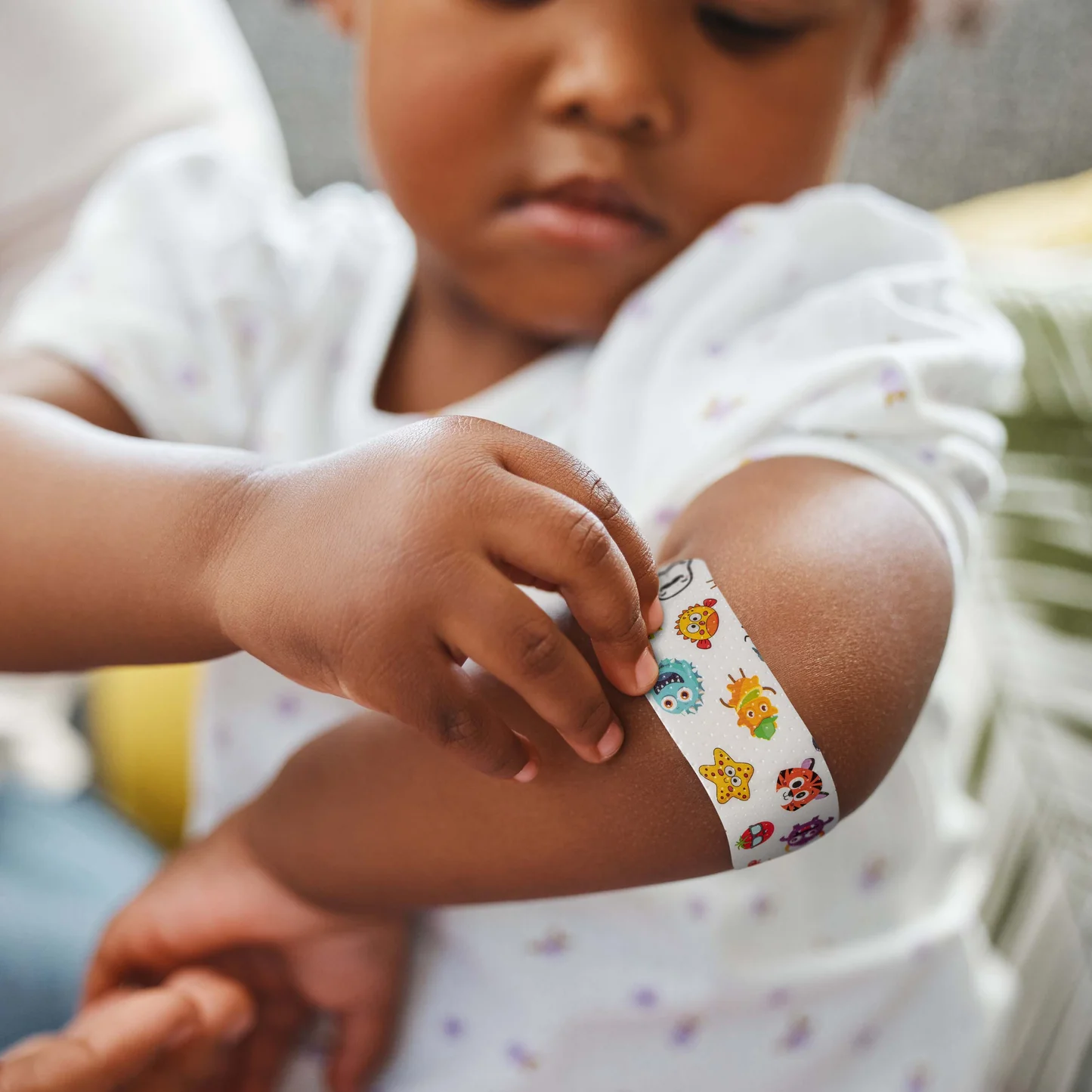 Child putting a Brandage bandage on their arm