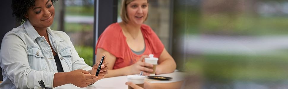 Simply easy. Woman is using Softclix device to quickly check sugars during a coffee break at work