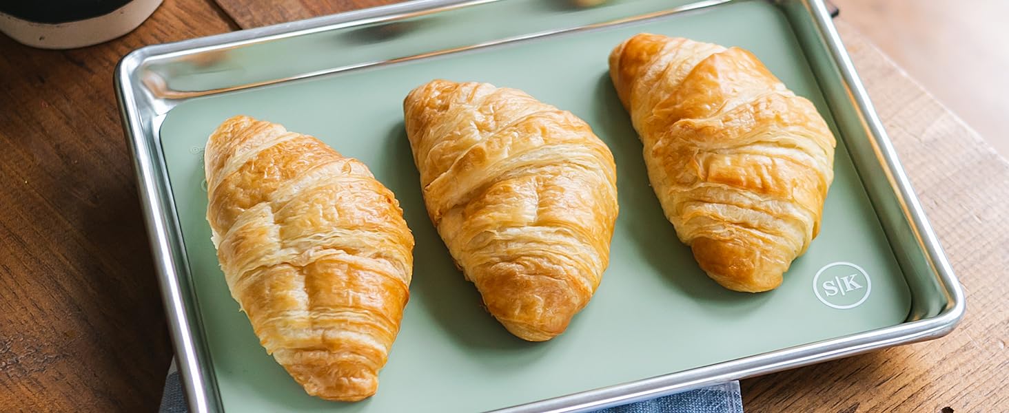 Sage green silicone baking sheet in quarter sheet size with croissants