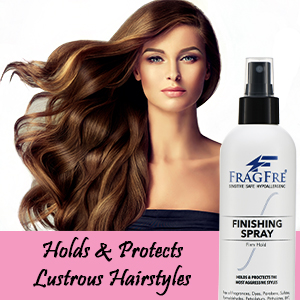White lady with glowing hair posing with a bottle of fragfre firm hold hair finishing spray