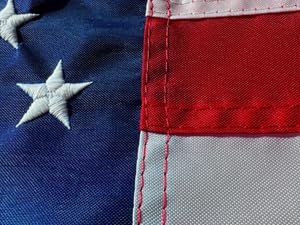 Sewn stripes close-up on nylon American flag with clean stitching