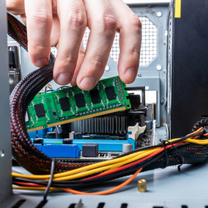 hand installing desktop module into slot inside desktop machine