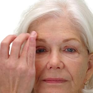 image of fifty five year old woman dabbing Insta Tox on her forehead