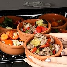 Mexican clay cookware set with terracotta pots, bowls and serving dishes for diverse cuisines.