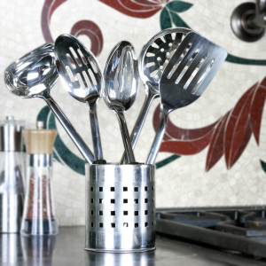 a metal container filled with metal kitchen spoons and utensils