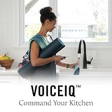 Image of a woman putting her water bottle under the faucet with water on