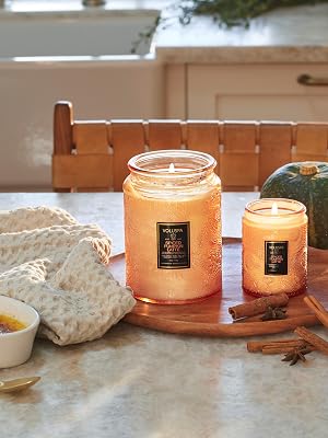Spiced Pumpkin Latte candles with Creme Brulee dessert, cinnamon sticks &amp; a coffee mug on a table.