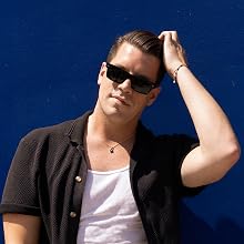 Model styling his hair with Clay Pomade