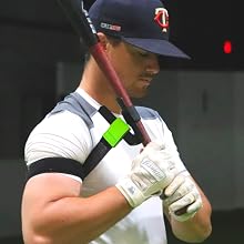 baseball player demonstrating swingrail swing trainer