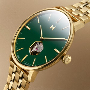 Featuring a 60’s dress silhouette, rich alligator embossed straps and an exposed heartbeat.