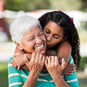 Granddaughter hugging and kissing her grandmother