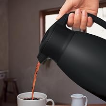 coffee being poured from a black carafe