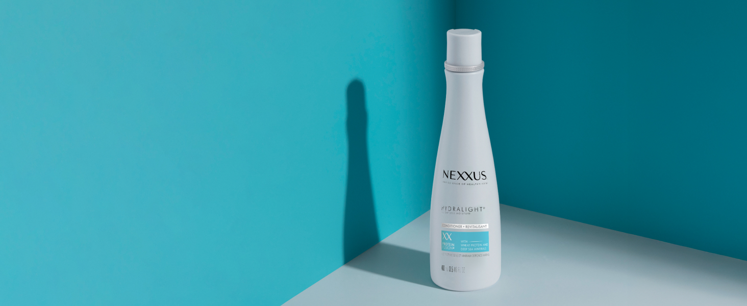 Nexxus Hydra-Light shampoo bottle in a blue corner.