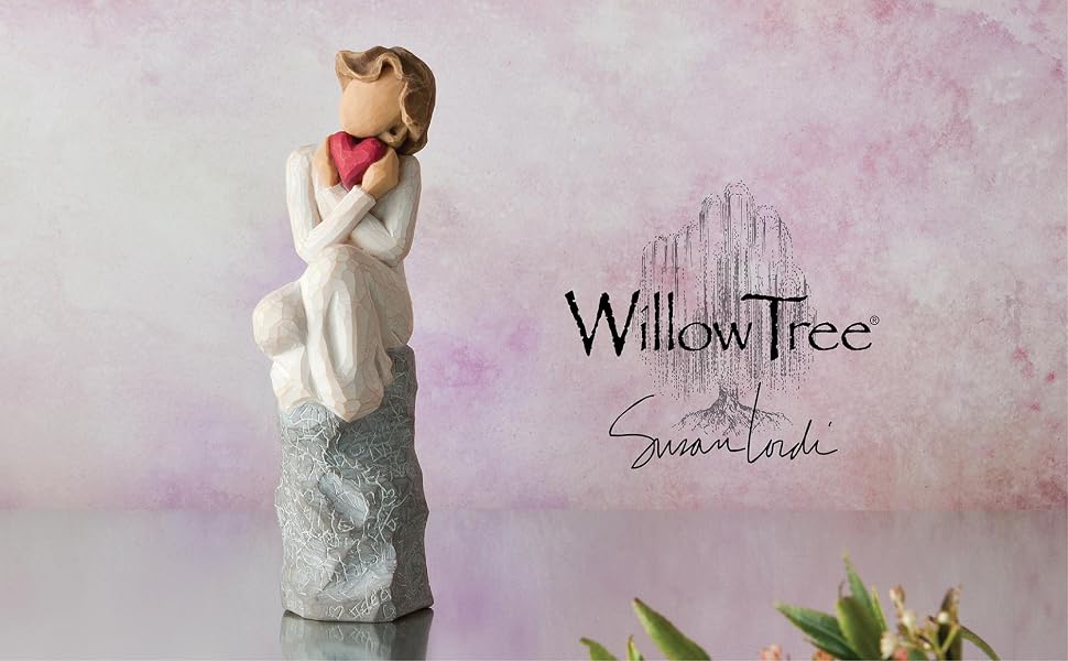 Willow Tree Always figure seated with knees drawn up to chest, holding red heart up to face.