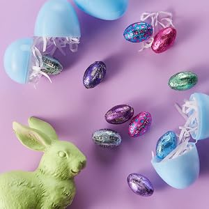 A variety of plastic Easter eggs filled with HERSHEY'S egg shaped candies in pastel foils