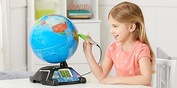 Kid listens, watches, and learns from LeapFrog Magic Adventures Globe.