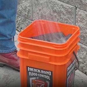 Flood Barrier being activated with hose in bucket