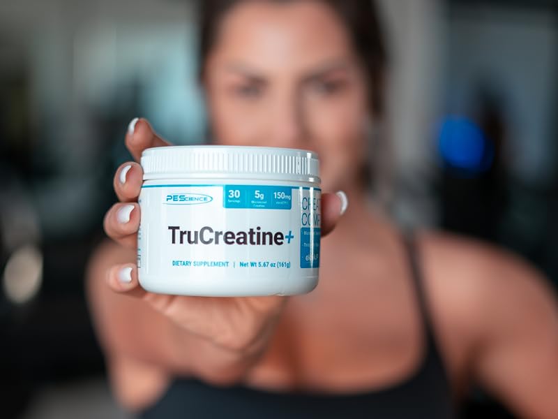 Girl holding trucreatine out of focus background