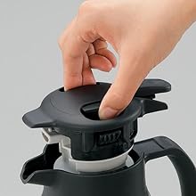 a hand removes the stopper by pinching the top