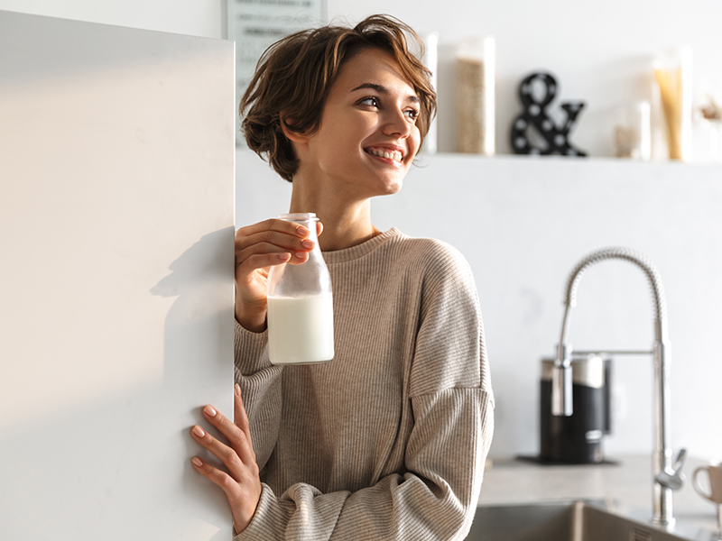 woman holding bottle of milk