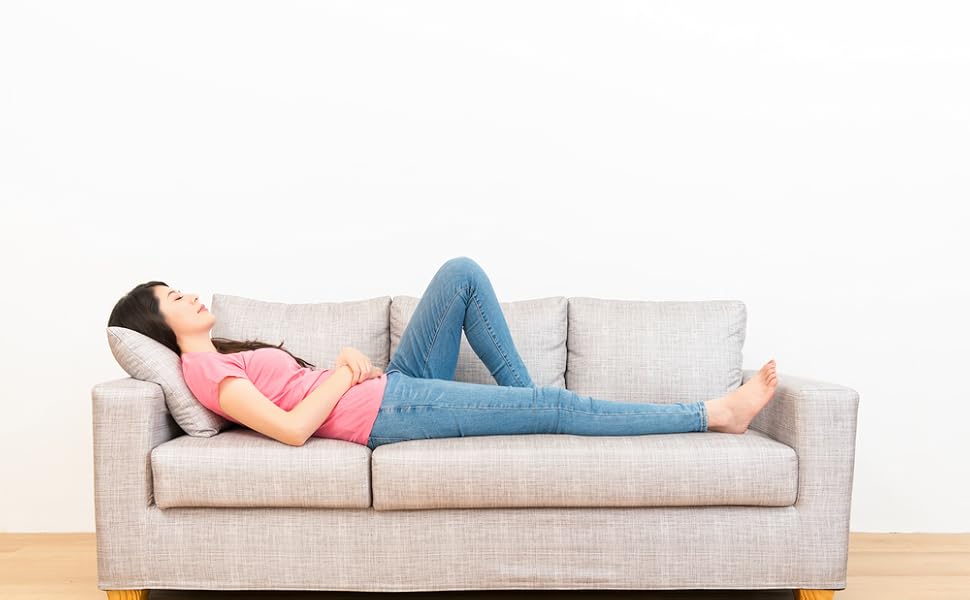 Woman laying comfortably on sofa
