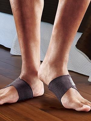 male feet wearing FUTURO arch support on wood floor