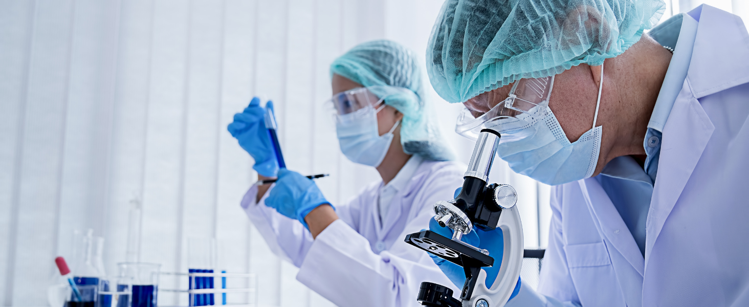 people in a lab looking into microscope