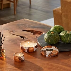 Spiced Pumkpin Latte Diffuser, Mini Tin and 3 Wick Candle clustered on a wood dining table.