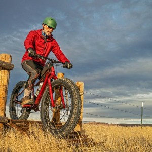 Senior mountain biker riding on trail